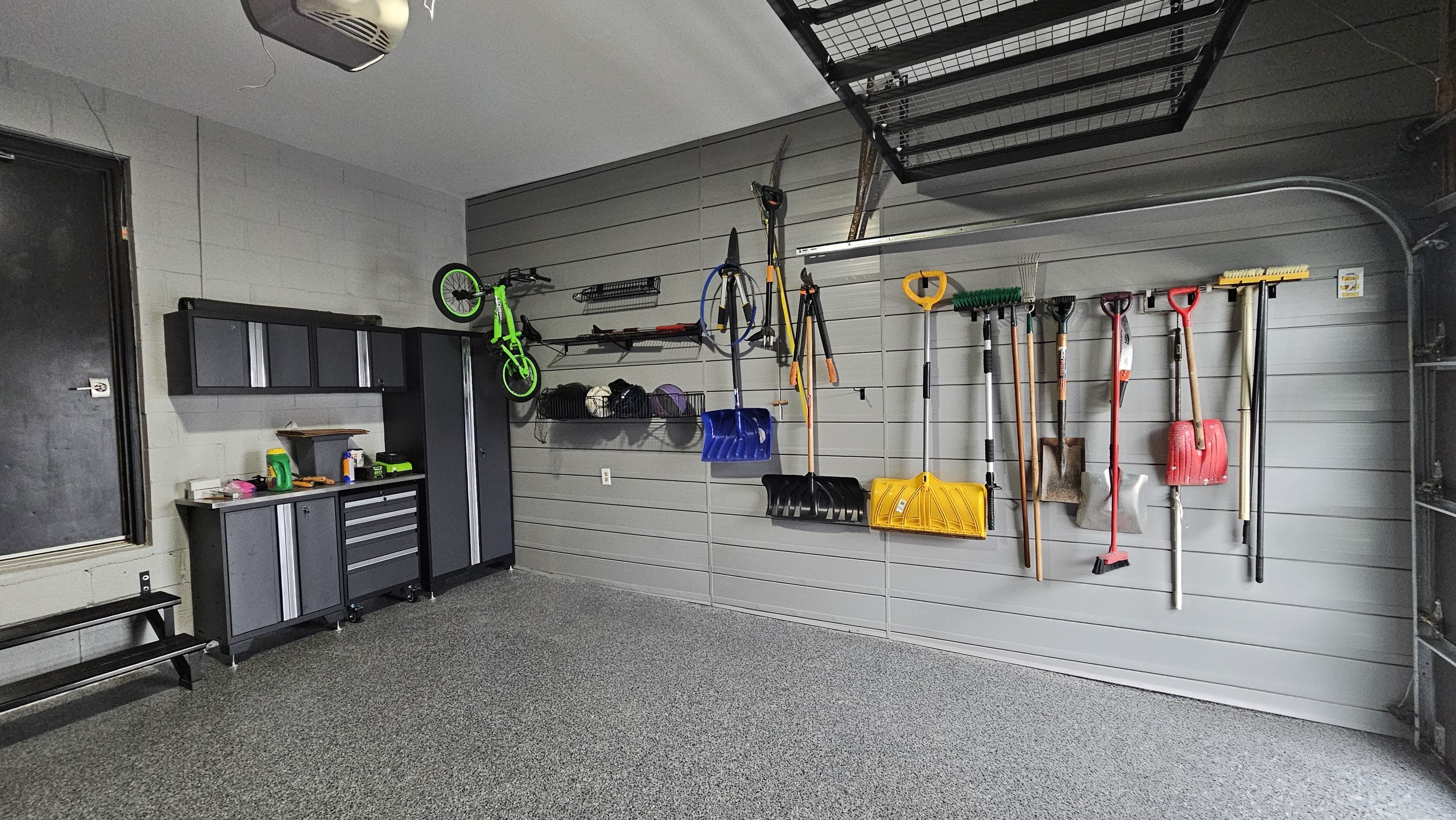 Completed Mint Garage installation with SmartSlat wall storage, cabinets, and epoxy flooring