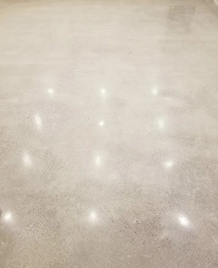 Warm light reflected across a polished concrete surface