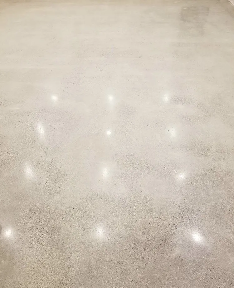 Warm light reflected across a polished concrete surface